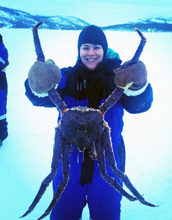 Woman holding a large crab